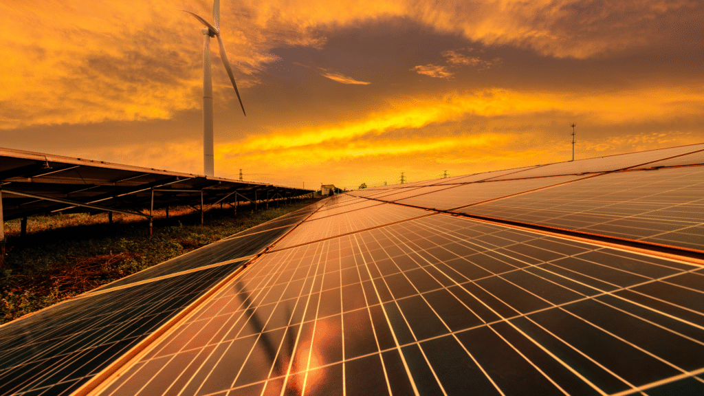 Solar panels and wind turbine at sunset generating renewable energy and sustainable power